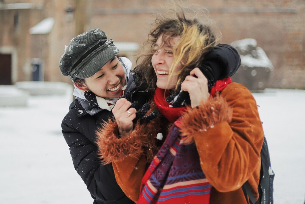 friends laughing in snow